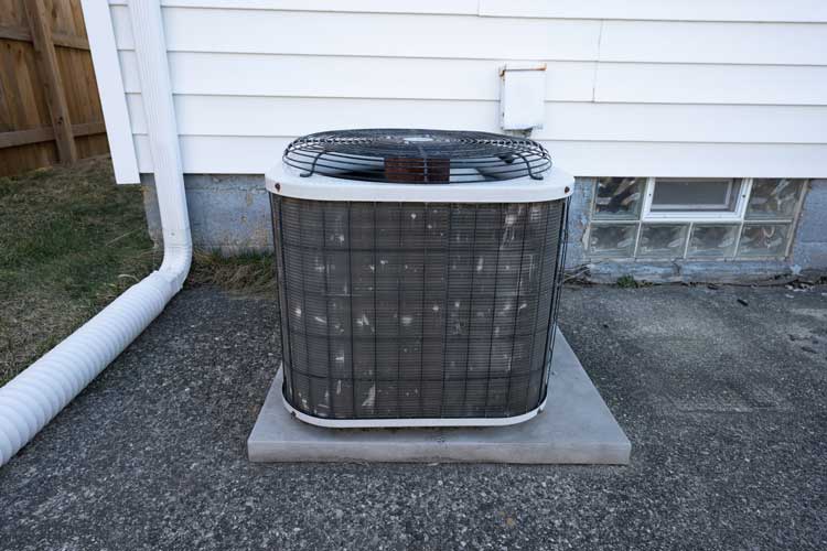 AC unit sitting outside of a house