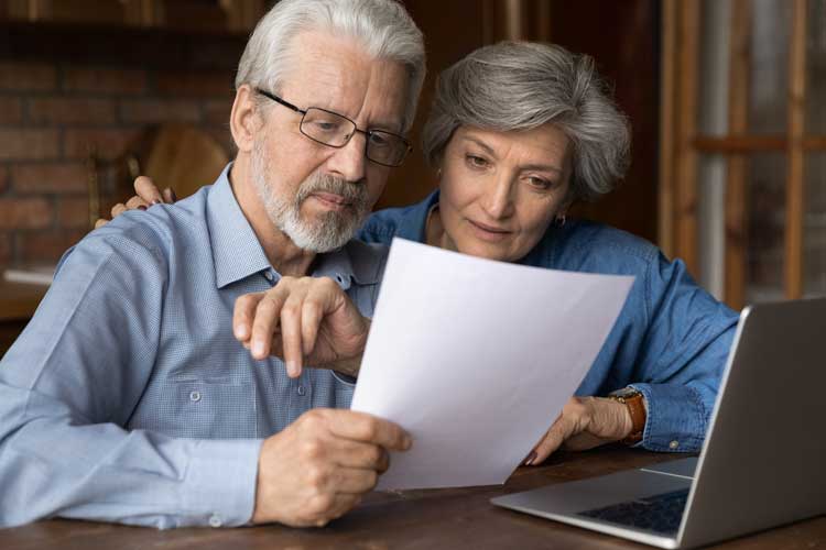 old couple reviewing furnace specs before buying