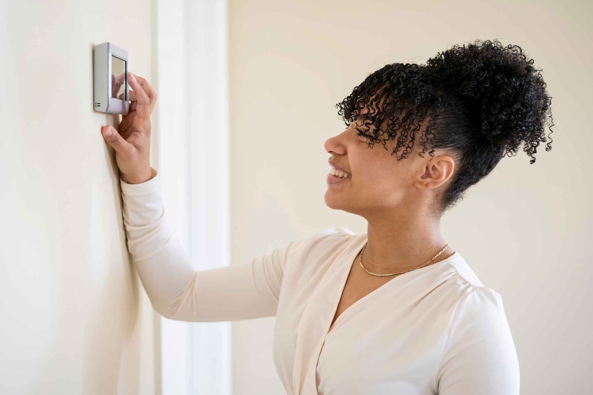 Women setting thermostat